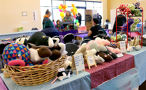 A vendor table covered in rat plushies